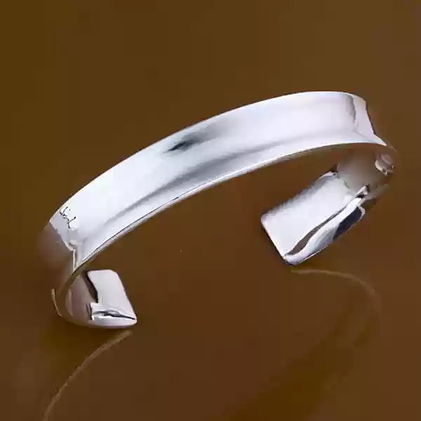 The wide silver cuff is timeless and chic